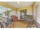 Relax on this covered porch featuring lovely seating options and a peaceful atmosphere at 106 Pine Trce, Ocala, FL 34472