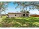 Side view of house highlighting back yard, screened in patio, and privacy fence at 106 Pine Trce, Ocala, FL 34472