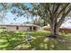 Expansive backyard featuring mature trees, lush green grass, and outdoor equipment at 106 Pine Trce, Ocala, FL 34472