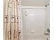 This bathroom features a standard white tub/shower combination and palm-themed shower curtain at 106 Pine Trce, Ocala, FL 34472