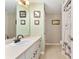 Well-lit bathroom features a vanity with ample storage and a shower-tub combo with charming palm tree decor at 106 Pine Trce, Ocala, FL 34472