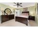 This primary bedroom features a beautiful hardwood bed frame and stylish dressers at 106 Pine Trce, Ocala, FL 34472