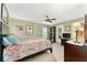 This charming bedroom features a ceiling fan, and a beautiful colorful bedspread at 106 Pine Trce, Ocala, FL 34472