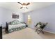 Comfortable bedroom features a ceiling fan, a large window, and a reading chair at 106 Pine Trce, Ocala, FL 34472