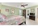 This charming bedroom features a ceiling fan, and a beautiful colorful bedspread at 106 Pine Trce, Ocala, FL 34472