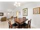 Bright dining area with a wooden table, neutral walls, and access to other living spaces at 106 Pine Trce, Ocala, FL 34472