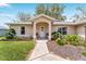 Inviting front entrance featuring a covered porch and decorative landscaping at 106 Pine Trce, Ocala, FL 34472