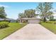 Charming single story home with a well-manicured lawn and long concrete driveway at 106 Pine Trce, Ocala, FL 34472