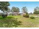 Charming single story home featuring a well-manicured lawn, mature trees and a welcoming front entrance at 106 Pine Trce, Ocala, FL 34472