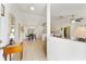 Spacious interior showcasing the seamless flow between the living room, dining area, and kitchen, accentuated by neutral tiling at 106 Pine Trce, Ocala, FL 34472