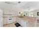 Bright kitchen with white appliances and a breakfast bar perfect for casual dining and entertaining at 106 Pine Trce, Ocala, FL 34472