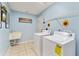 Bright laundry room with a utility sink, washer, dryer, and tile flooring at 106 Pine Trce, Ocala, FL 34472