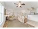 Cozy living room with neutral tones, a ceiling fan, and seamless access to other areas of the home at 106 Pine Trce, Ocala, FL 34472