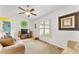 Cozy living room with neutral tones, a ceiling fan, and a large window with natural light at 106 Pine Trce, Ocala, FL 34472