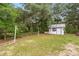 Spacious backyard with a shed, a clothesline, and plenty of room for outdoor activities at 10671 Ne 152Nd Ln, Fort Mc Coy, FL 32134
