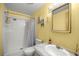 Well-lit bathroom with a shower-tub combo, neutral walls, and tile surround at 10671 Ne 152Nd Ln, Fort Mc Coy, FL 32134