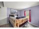Bright bedroom with wood-look floors, natural light, and cozy floral bedding at 10671 Ne 152Nd Ln, Fort Mc Coy, FL 32134