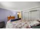 Cozy bedroom with soft floral bedding and a modern closet storage system at 10671 Ne 152Nd Ln, Fort Mc Coy, FL 32134
