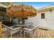 Outdoor deck area with a table and chairs, shaded by a large umbrella at 10671 Ne 152Nd Ln, Fort Mc Coy, FL 32134