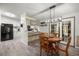 Dining area with wood table and chairs, open to the kitchen, with bright natural lighting at 10671 Ne 152Nd Ln, Fort Mc Coy, FL 32134