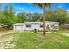 Exterior view of a single-story house with attached garage and front deck at 10671 Ne 152Nd Ln, Fort Mc Coy, FL 32134
