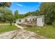 Charming single-story home with a wooden porch and well-maintained lawn at 10671 Ne 152Nd Ln, Fort Mc Coy, FL 32134