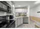 Modern kitchen with stainless steel appliances, light countertops, and wood-look flooring at 10671 Ne 152Nd Ln, Fort Mc Coy, FL 32134