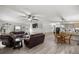 Open-concept living room and kitchen area with modern ceiling fan and bright lighting at 10671 Ne 152Nd Ln, Fort Mc Coy, FL 32134