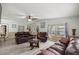 Spacious living room with laminate floors, leather furniture, and large windows at 10671 Ne 152Nd Ln, Fort Mc Coy, FL 32134