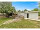 Back exterior of the house with a screened-in porch and an attached garage at 10671 Ne 152Nd Ln, Fort Mc Coy, FL 32134