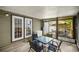 Enclosed sunroom featuring a seating area and a view of the outdoor deck at 10671 Ne 152Nd Ln, Fort Mc Coy, FL 32134