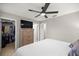 Bedroom with a ceiling fan, dresser with TV and a walk-in closet provides ample storage space at 11326 Se 175Th Pl, Summerfield, FL 34491