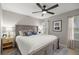 Comfortable bedroom features a ceiling fan, stylish headboard and a decorative area rug at 11326 Se 175Th Pl, Summerfield, FL 34491
