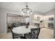 Open concept dining area connecting to the kitchen, featuring a stylish chandelier at 11326 Se 175Th Pl, Summerfield, FL 34491