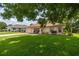 Charming single story home with a well-manicured lawn, brick driveway, and cozy front porch at 11326 Se 175Th Pl, Summerfield, FL 34491