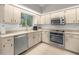 Well-lit kitchen features stainless steel appliances and plenty of countertop space at 11326 Se 175Th Pl, Summerfield, FL 34491
