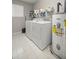 Well-lit laundry area equipped with washer, dryer, utility sink and water heater at 11326 Se 175Th Pl, Summerfield, FL 34491