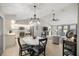 Open concept living space with modern kitchen, dining area, and comfortable seating at 11326 Se 175Th Pl, Summerfield, FL 34491