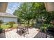 Paver patio area featuring outdoor seating, mature trees, and a backyard swing at 11326 Se 175Th Pl, Summerfield, FL 34491