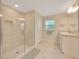 Bright bathroom featuring a glass-enclosed shower, vanity with granite countertops, and tile flooring at 130 Nw 113Th Cir, Ocala, FL 34482