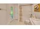 Bathroom with shower-tub combo, exterior window, and door to the outdoor at 130 Nw 113Th Cir, Ocala, FL 34482