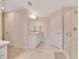 Bathroom featuring tile flooring, double sinks with granite countertops, and a tiled walk-in shower at 130 Nw 113Th Cir, Ocala, FL 34482