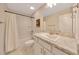 Clean bathroom featuring a tub with shower, a white granite countertop, and ample lighting, providing a fresh aesthetic at 130 Nw 113Th Cir, Ocala, FL 34482