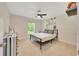 Comfortable bedroom with carpet flooring, ceiling fan, and natural light from the window at 130 Nw 113Th Cir, Ocala, FL 34482