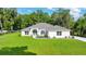 Beautiful one story home with a spacious front yard, well manicured landscaping, and a gray roof at 130 Nw 113Th Cir, Ocala, FL 34482