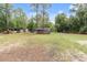 Expansive backyard featuring an above ground pool, trampoline, shed, and mature trees at 16082 Sw 24Th Pl, Ocala, FL 34481