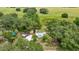 An aerial view of a property showing the home, surrounding trees, and expansive greenery at 22535 Sw 117Th St, Dunnellon, FL 34431