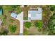 Bird's-eye view of the home, with a long driveway, metal roof, and landscaped yard at 22535 Sw 117Th St, Dunnellon, FL 34431
