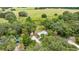 Aerial shot of the home on a spacious lot, featuring a long driveway and a separate structure at 22535 Sw 117Th St, Dunnellon, FL 34431