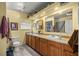 Bathroom featuring a full vanity, granite countertop, and an oversized mirror and lighting at 22535 Sw 117Th St, Dunnellon, FL 34431